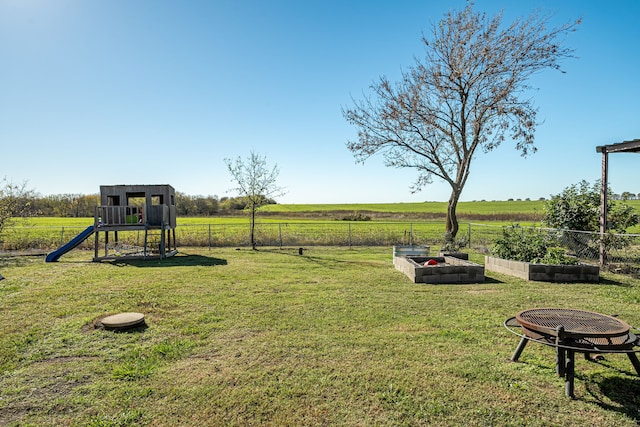 view of yard featuring a playground and a rural view