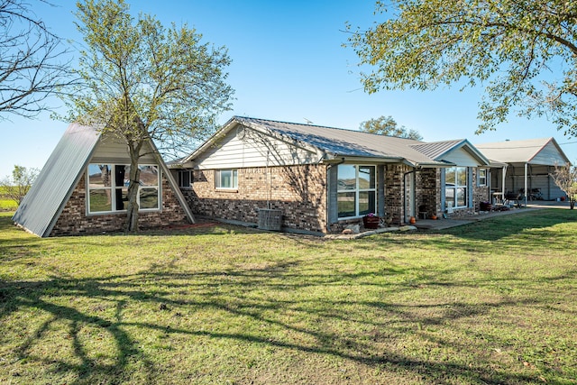 view of front of property with a front lawn and central AC unit