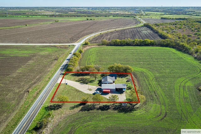 birds eye view of property with a rural view