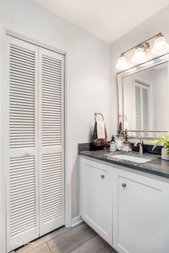 bathroom featuring hardwood / wood-style flooring and vanity