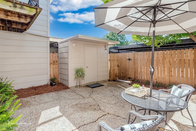 view of patio featuring a storage shed