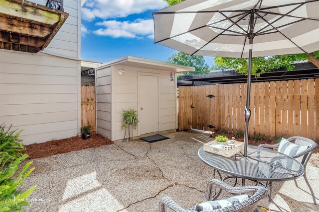 view of patio featuring a storage shed