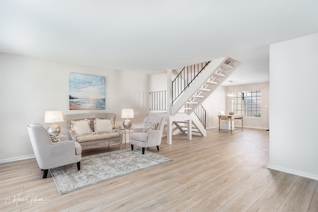 living room featuring stairway, wood finished floors, and baseboards