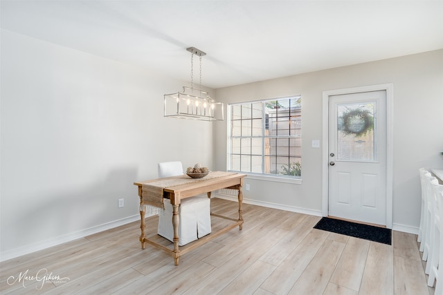 dining area with an inviting chandelier and light wood-type flooring