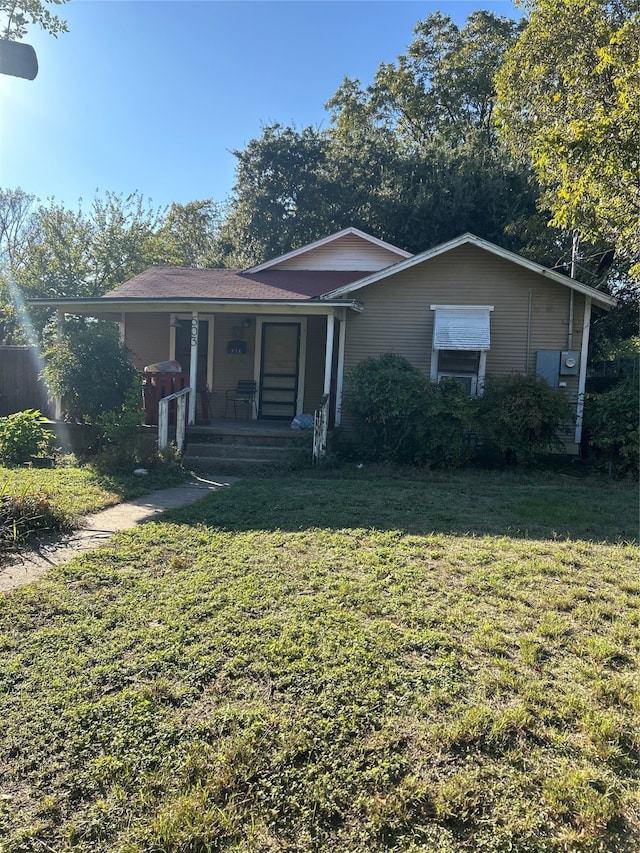 view of front of home with a porch and a front yard