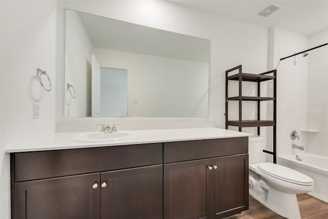 full bathroom with hardwood / wood-style flooring, vanity, toilet, and shower / bath combination