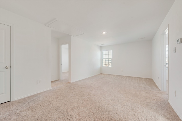 spare room with light colored carpet