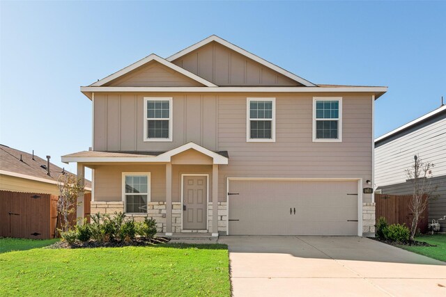 view of front of house with a front yard and a garage