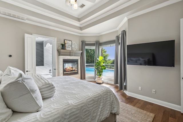 bedroom with a multi sided fireplace, wood-type flooring, ceiling fan, and crown molding