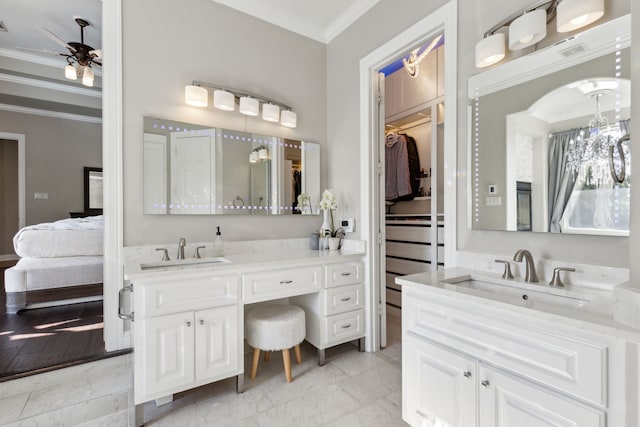 bathroom with ceiling fan, vanity, and ornamental molding