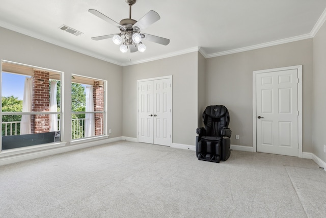 unfurnished bedroom with ceiling fan, light colored carpet, crown molding, and a closet