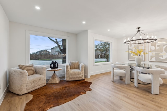 sitting room featuring light hardwood / wood-style floors and a chandelier