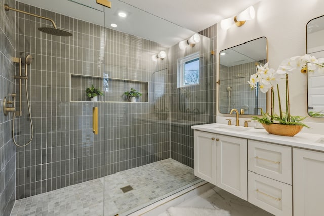 bathroom with vanity and a shower with door