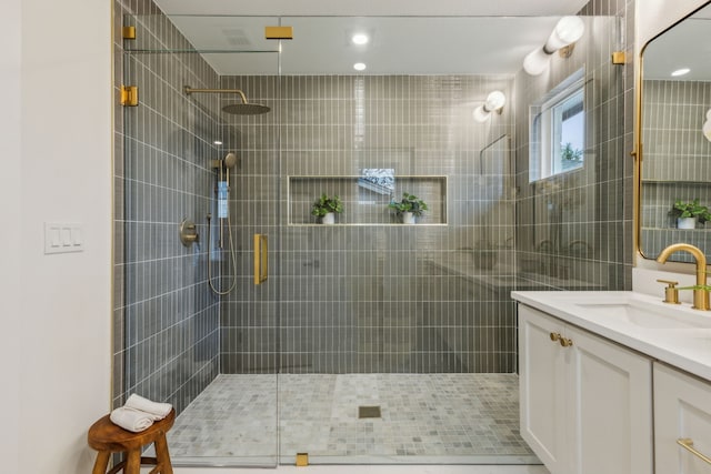 bathroom featuring vanity and an enclosed shower