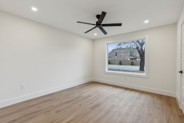 spare room featuring ceiling fan and light wood-type flooring