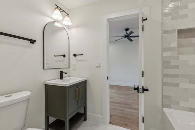 bathroom with vanity, toilet, and ceiling fan