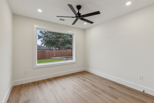 spare room with light wood-type flooring and ceiling fan