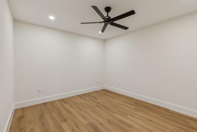 spare room with ceiling fan and light hardwood / wood-style flooring