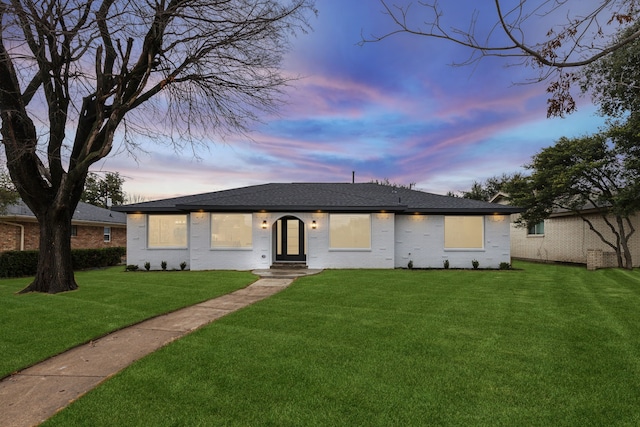 ranch-style home featuring a yard