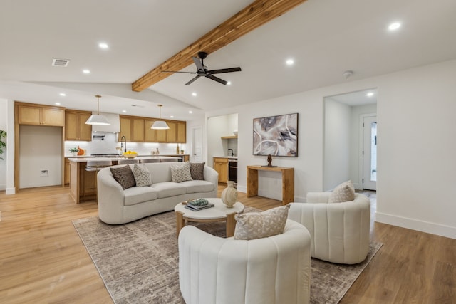 living room with vaulted ceiling with beams, ceiling fan, light wood-type flooring, and wine cooler