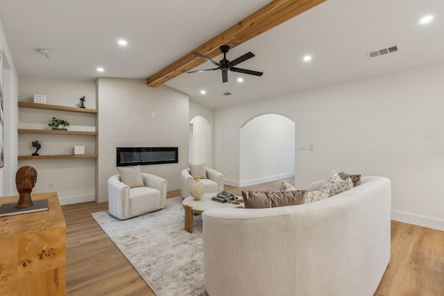 living room featuring vaulted ceiling with beams, ceiling fan, and light hardwood / wood-style floors