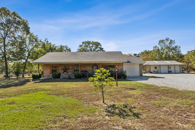 single story home with a garage and a front lawn