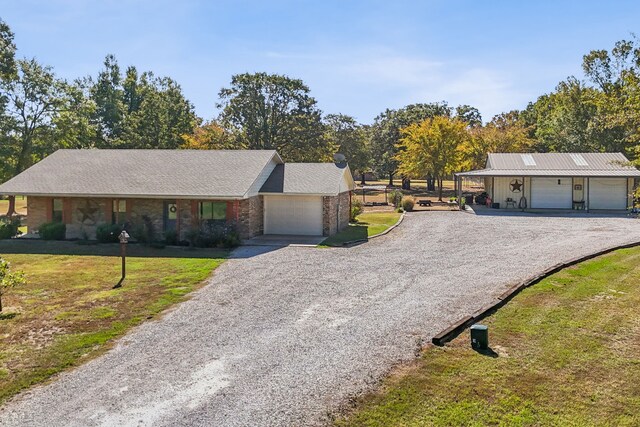 ranch-style home featuring a garage and a front lawn