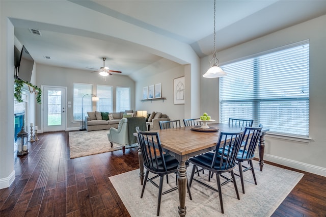 dining room featuring ceiling fan, dark wood-type flooring, and vaulted ceiling