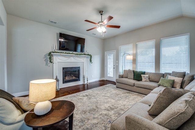 living room with ceiling fan, dark hardwood / wood-style flooring, and lofted ceiling