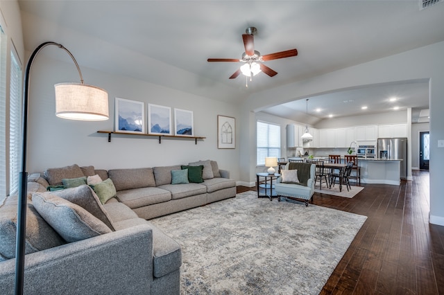 living room featuring dark hardwood / wood-style flooring and ceiling fan