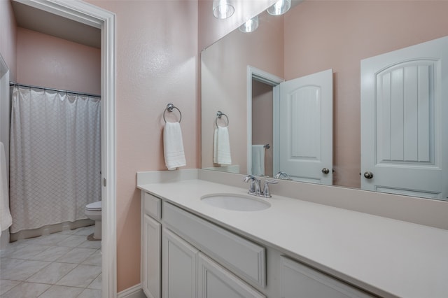 bathroom featuring tile patterned flooring, vanity, a shower with shower curtain, and toilet