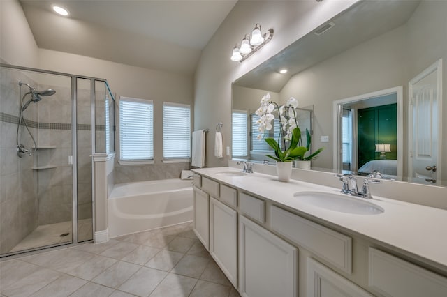 bathroom featuring shower with separate bathtub, vanity, tile patterned floors, and lofted ceiling