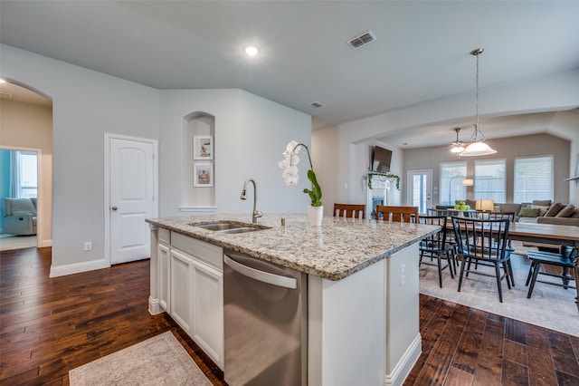 kitchen featuring dark hardwood / wood-style flooring, dishwasher, an island with sink, and hanging light fixtures