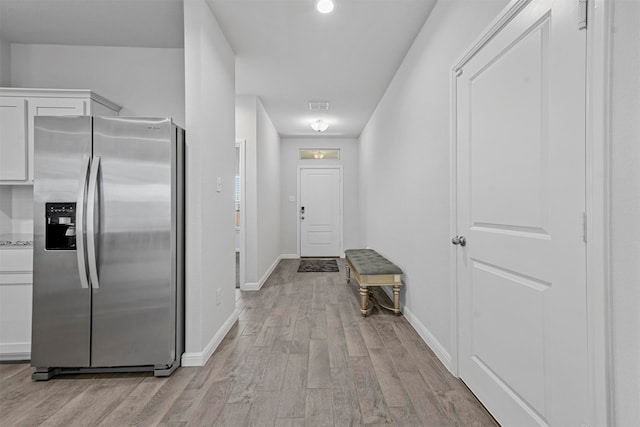 hallway with light hardwood / wood-style flooring