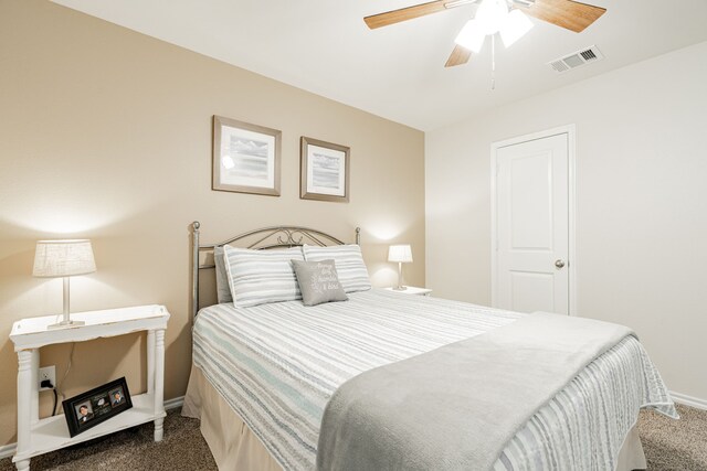 bedroom with ceiling fan and dark colored carpet