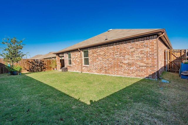 rear view of property with a lawn