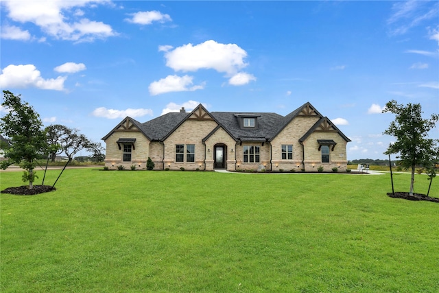 french country style house featuring a front lawn