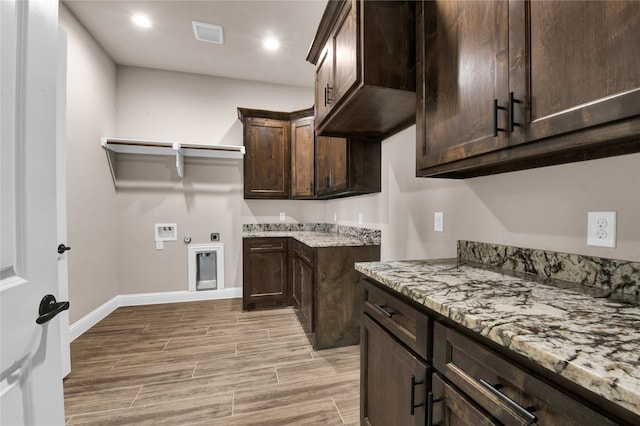 washroom with electric dryer hookup, cabinets, hookup for a washing machine, and hookup for a gas dryer