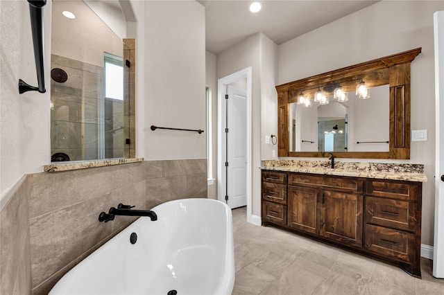 bathroom featuring separate shower and tub, tile patterned floors, and vanity