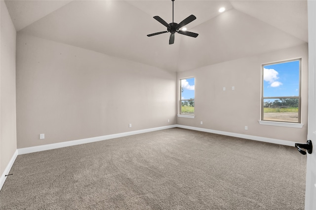 carpeted empty room featuring ceiling fan, plenty of natural light, and high vaulted ceiling