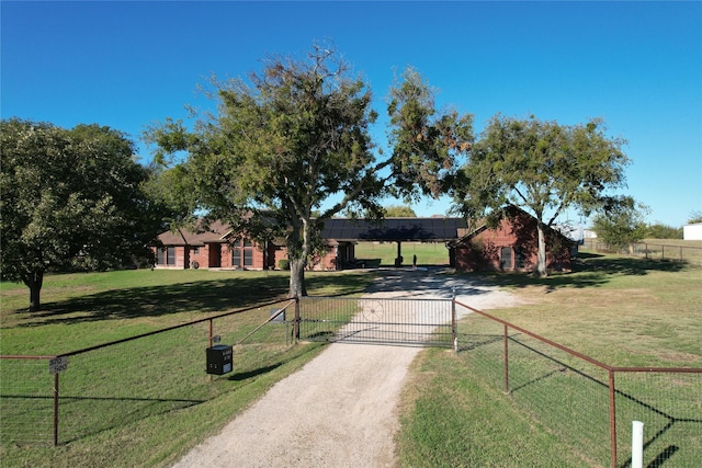 view of front of home featuring a front yard, a gate, driveway, and fence