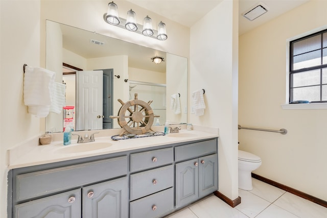 bathroom featuring tile patterned flooring, vanity, toilet, and a shower with shower door