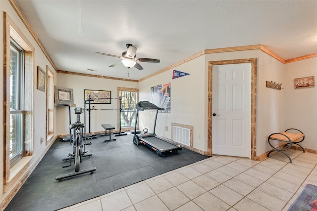 workout room with ceiling fan, crown molding, and light tile patterned floors