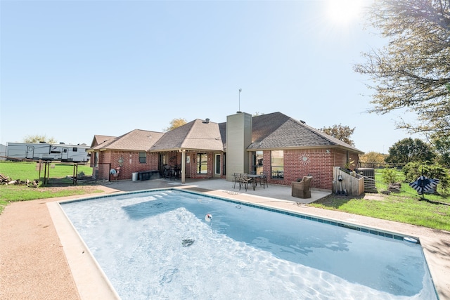 view of pool with a yard and a patio