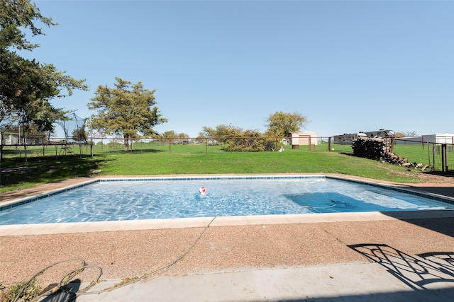 view of pool featuring a yard