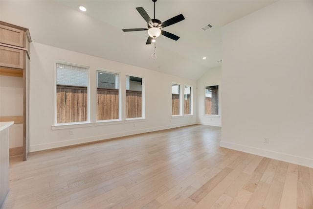 unfurnished living room featuring visible vents, lofted ceiling, baseboards, a ceiling fan, and light wood-style flooring