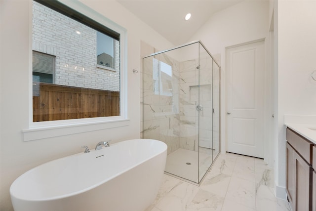 bathroom featuring vanity, marble finish floor, a marble finish shower, and a freestanding bath