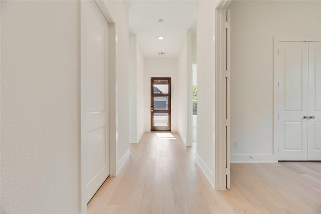 corridor featuring recessed lighting, baseboards, light wood finished floors, and visible vents