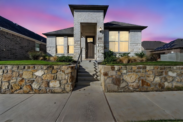 view of exterior entry at dusk