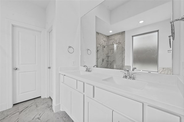 bathroom featuring double vanity, marble finish floor, a marble finish shower, and a sink